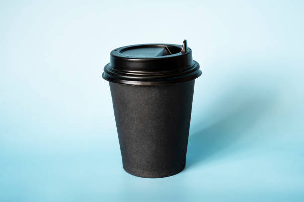 istock Black paper coffee mug on a blue background. Empty space for text and design on a cup of coffee. form for the name of the coffee or company or coffee shop 1438023180