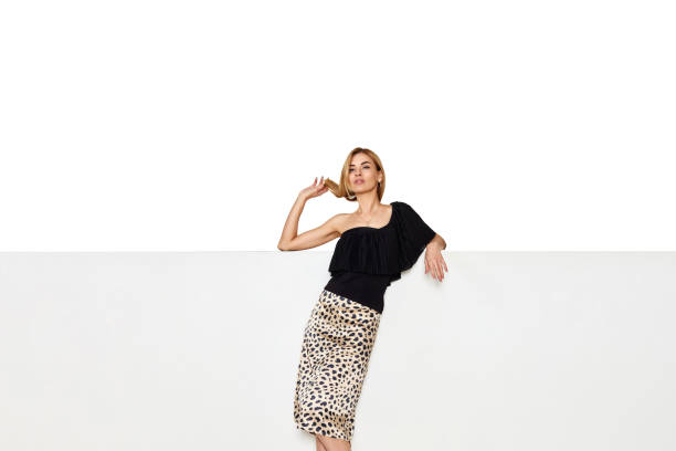 istock blonde woman with long legs sitting on white bench. 1438024768