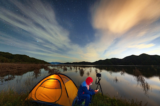 Lakeside photographer under the starry sky