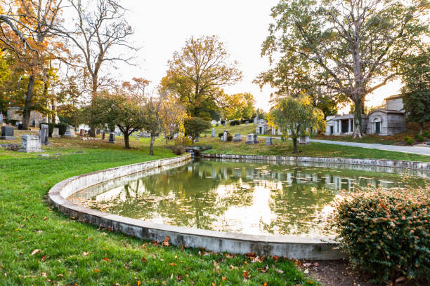 Washington, DC USA - November 4, 2019: Trees reflect in the pond at the historic Rock Creek Cemetery dating back to the Colonial period in Washington, DC