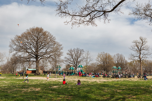Washington, DC USA - March 23, 2016: Families and children playing on the playground equipment at East Potomac Park in Washington, DC