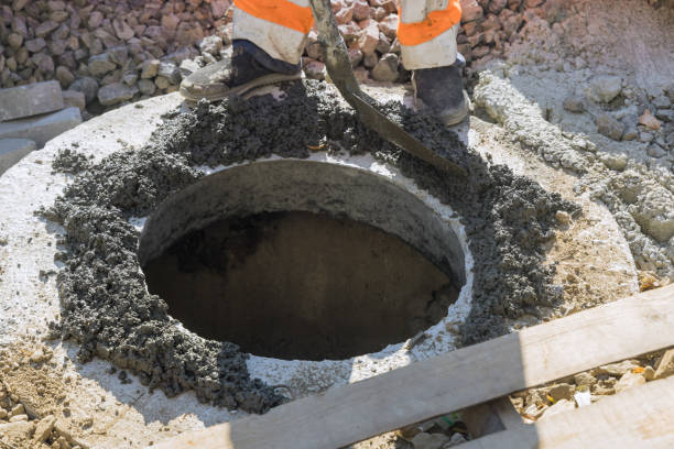 istock In the construction site of a new construction, a cast iron sewer hatch is being installed on a concrete base in order to install a water sewer well in the ground. 1438029411