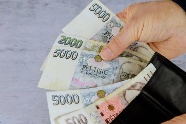 istock A man counting Czech korunas in his wallet while holding Czech banknotes from the Czech Republic 1438029413
