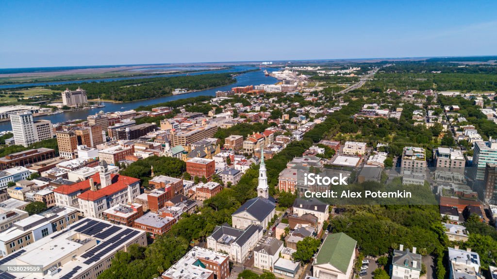 Aerial view of the Historic District in Downtown Savannah, Georgia, with  Independent Presbyterian Church and new administrative buildings in the foreground, and a distant view of the Savannah River in the backdrop. Aerial view of the Historic District in Downtown Savannah, Georgia, with  Independent Presbyterian Church in the foreground, and a distant view of the Savannah River in the backdrop. Aerial View Stock Photo