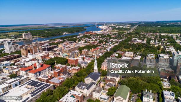 Aerial View Of The Historic District In Downtown Savannah Georgia With Independent Presbyterian Church And New Administrative Buildings In The Foreground And A Distant View Of The Savannah River In The Backdrop Stock Photo - Download Image Now