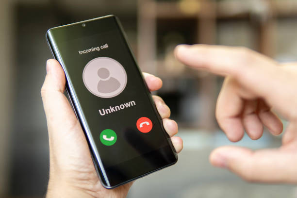 istock Phone call from unknown number. Scam, fraud or phishing with smartphone concept. Prank caller, scammer or stranger. Man answering to incoming call. Hoax person with fake identity. 1438029570