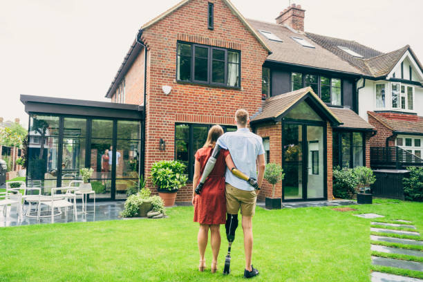 istock Proud young homeowners admiring their modern brick house 1438030272