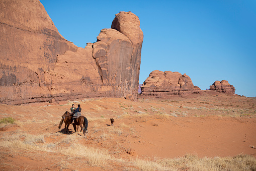 Navajo sisters riding on horses in Monument Valley