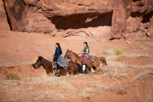 istock Navajo sisters riding slow pace on horses 1438032219