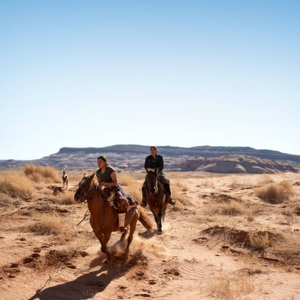 istock Sisters galloping on horses in the Arizona desert 1438032267