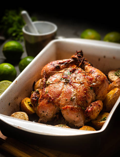 istock Whole roasted chicken with potatoes 1438032328