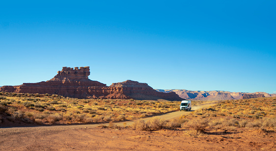 Delivery commercial van driving on a dirt road of the Arizona desert