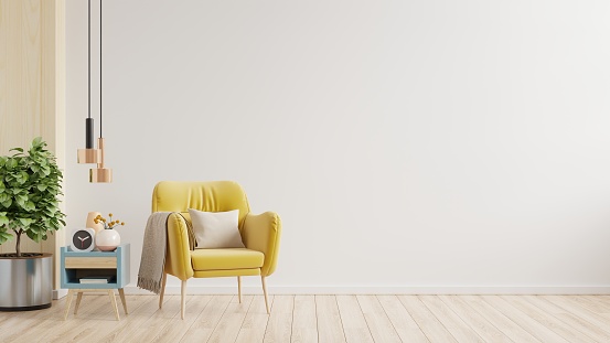 Yellow armchair on empty white wall background.3d rendering
