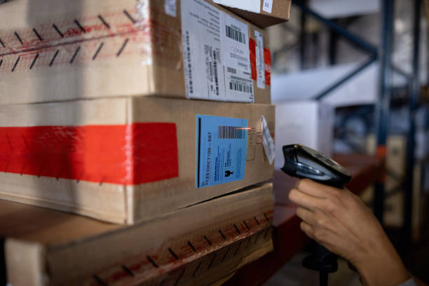 istock Close up of a worker scanning a box at a distribution warehouse 1438033272