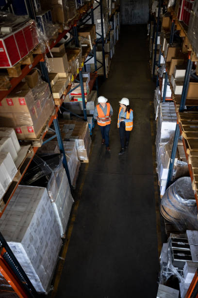 istock Workers discussing the logistics of storage at a distribution warehouse 1438033311