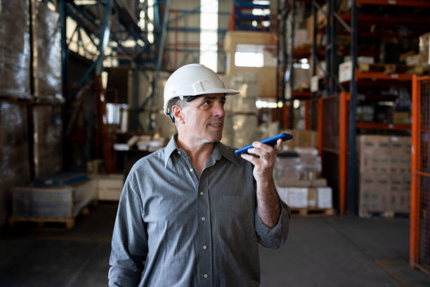 istock Business manager working at a distribution warehouse and talking on the phone 1438033327