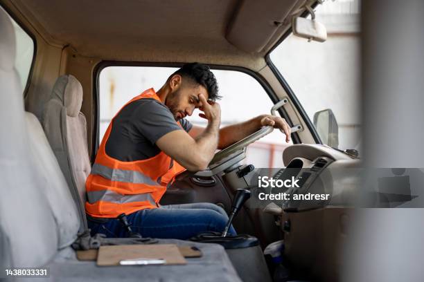 Tired Truck Driver Having A Headache After Working Extra Hours Stock Photo - Download Image Now