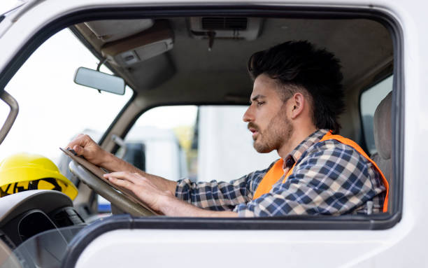 istock Truck driver checking his route before driving to his next destination 1438033339