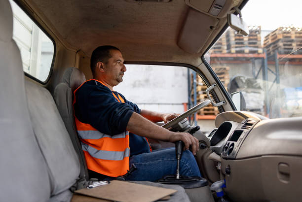 istock Truck driver driving a freight transportation vehicle 1438033342