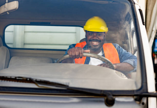 istock Happy truck driver smiling at the camera 1438034472