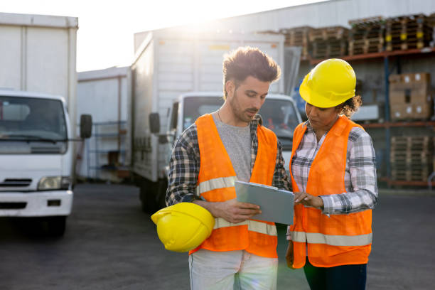 istock Supervisor talking to a truck driver before leaving to deliver some cargo 1438034476