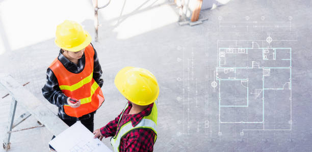istock Architect and client discussing help create plan with blueprint of the building at construction site floor. Asian engineer foreman worker man and woman meeting and planning construction work, top view 1438036554