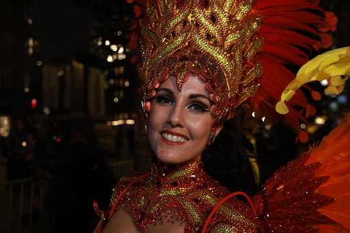Beautiful young woman in an amazing costume takes part in the parade of the carnival of Santa Cruz de Tenerife, that traditionally runs on the seafront. The Carnival of Santa Cruz de Tenerife is considered the second most popular carnival in the world, after the one of Rio de Janeiro.