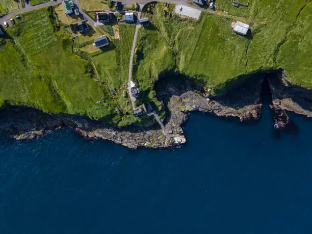 Beautiful aerial view of Sydradalur port and village near the Seal woman statue in the Faroe Islands