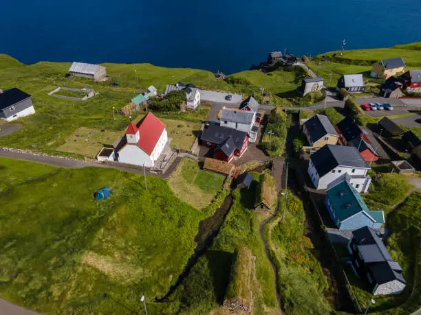 Beautiful aerial view of Sydradalur port and village near the Seal woman statue in the Faroe Islands