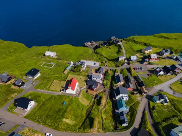 Beautiful aerial view of Sydradalur port and village near the Seal woman statue in the Faroe Islands