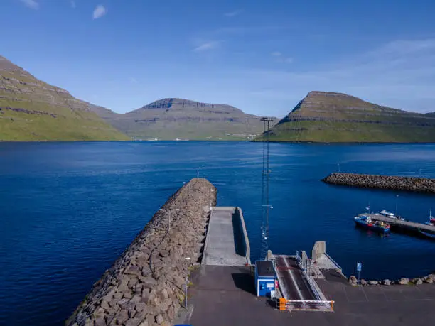 Beautiful aerial view of Sydradalur port and village near the Seal woman statue in the Faroe Islands