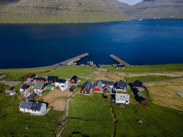 Beautiful aerial view of Sydradalur port and village near the Seal woman statue in the Faroe Islands