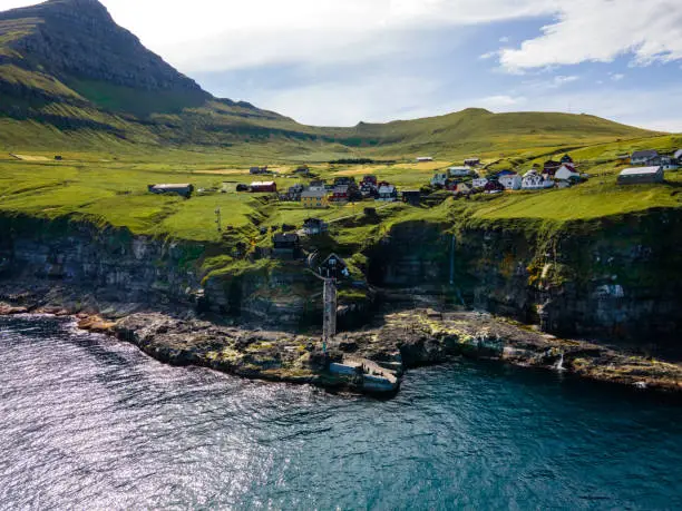 Beautiful aerial view of Sydradalur port and village near the Seal woman statue in the Faroe Islands