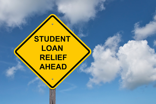 Student Loan Relief Ahead Caution Sign - Blue Sky Background