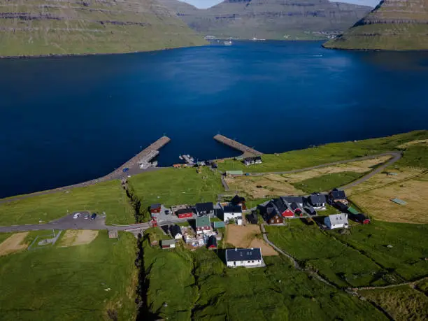 Beautiful aerial view of Sydradalur port and village near the Seal woman statue in the Faroe Islands