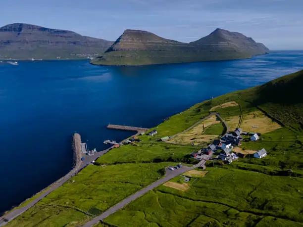 Beautiful aerial view of Sydradalur port and village near the Seal woman statue in the Faroe Islands