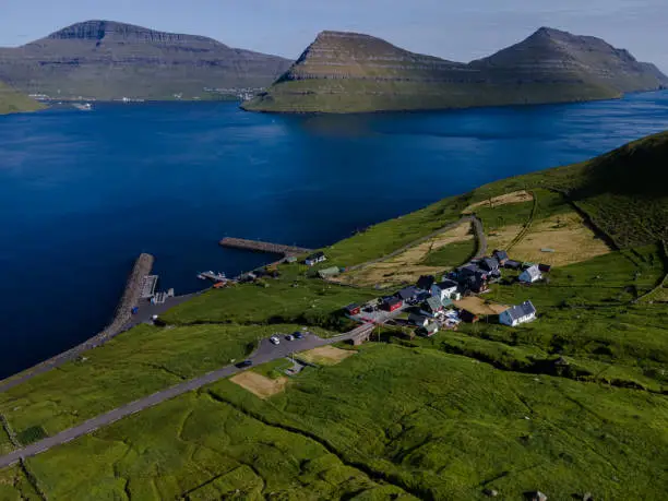 Beautiful aerial view of Sydradalur port and village near the Seal woman statue in the Faroe Islands