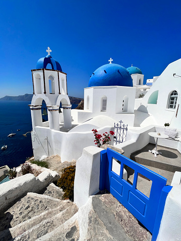 Old white church with blue cupola in Oia, Santorini.