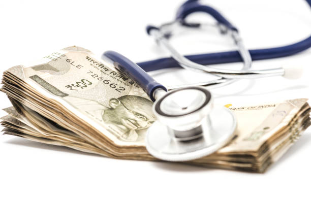 Indian currency and stethoscope stock photo