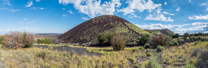 The San Francisco Volcanic Field spreads out over 1,800 square miles of northern Arizona.  This is an area of young volcanoes along the southern edge of the Colorado Plateau. During its 6 million year history, this field has produced more than 600 volcanoes. The varied landscape includes grasslands, forests and rugged mountains. This unnamed volcanic cinder cone is next to Doney Mountain in the Coconino National Forest near Flagstaff, Arizona, USA.