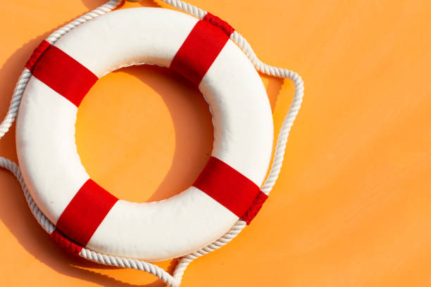 istock Lifebuoy on orange background. Copy space 1438046992