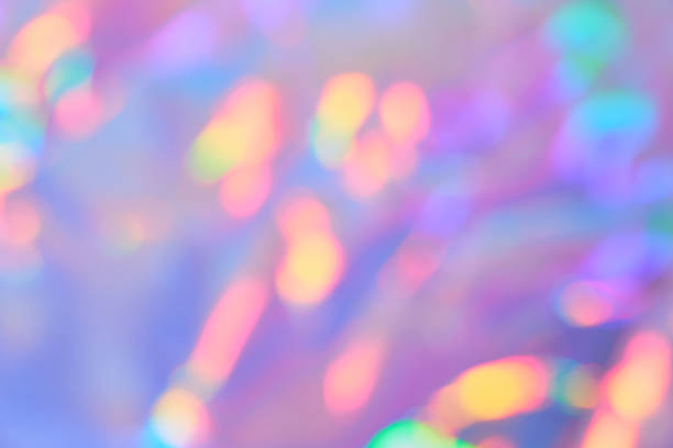Soft gradient background with Smooth Blurred holographic iridescent colors with golden bokeh. Festive glittering background.