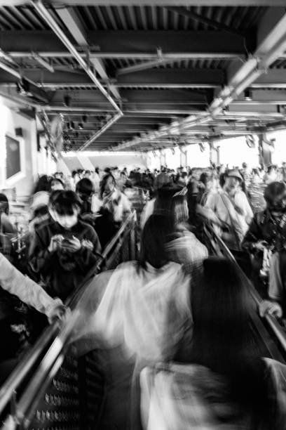 istock Crowd of people queuing, motion blur 1438056382