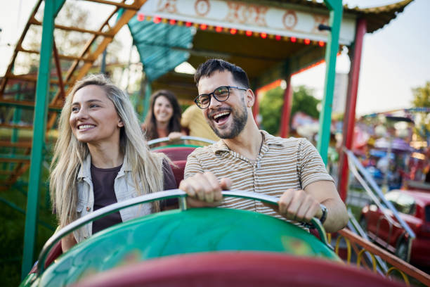 istock Young cheerful couple having fun on rollercoaster at amusement park. 1438066178