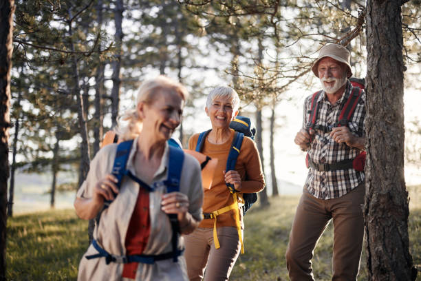 istock Happy senior friends hiking through the woods. 1438067706