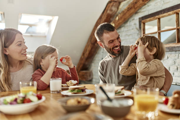 istock Happy family having fun during breakfast at dining table. 1438068799