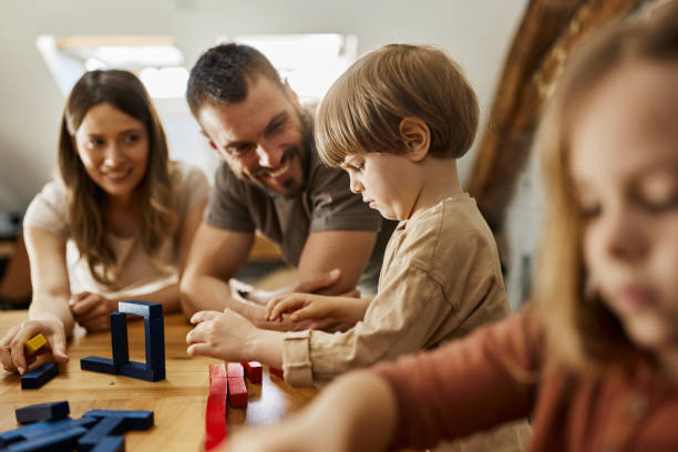 istock Young family playing with toy blocks at home. 1438068950