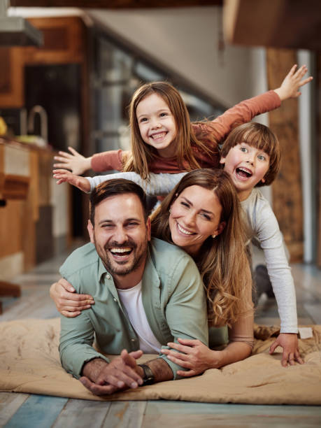 istock Young happy family having fun on floor at home. 1438069088