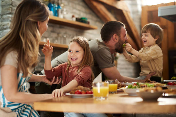 istock Happy family having fun during a meal in dining room. 1438069145