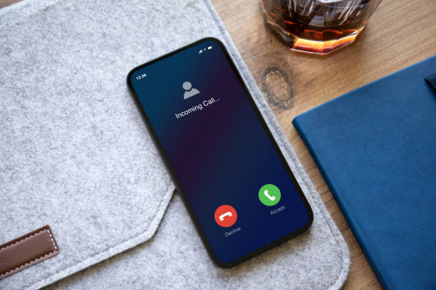 istock phone with incoming call on screen background table in office 1438075888